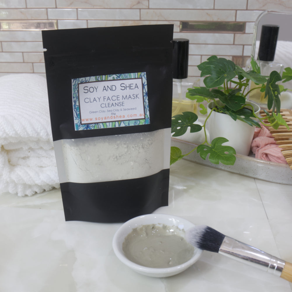 Soy and Shea Clay Face Mask package with a bowl of mask and brush on a bathroom counter.