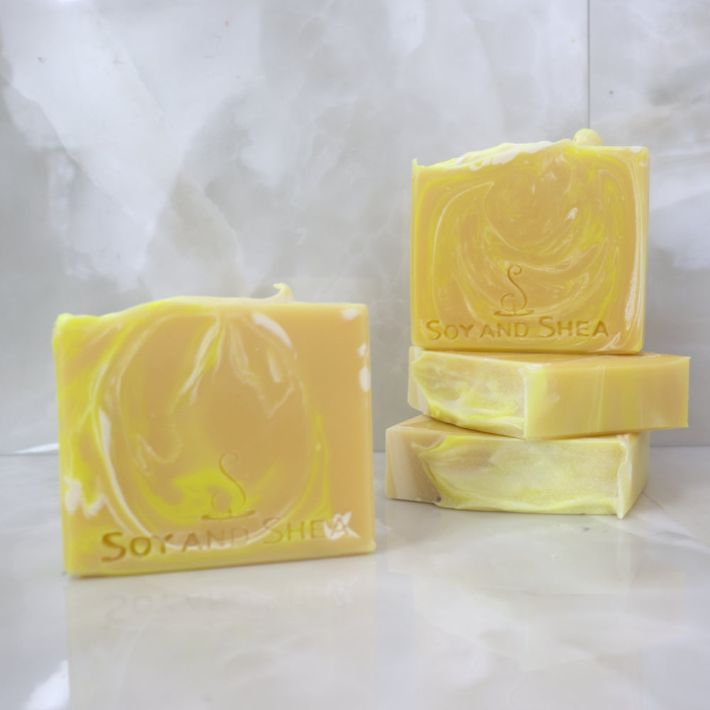 Yellow Swirled soap bars with 'Soy and Shea' branding on a white background