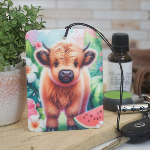 The Soy and Shea Baby Cow Car Air Freshener is a colorful, eco-friendly felt accessory featuring a cute baby cow beside a watermelon slice—perfect for your car, with aromatherapy oils for long-lasting fragrance.