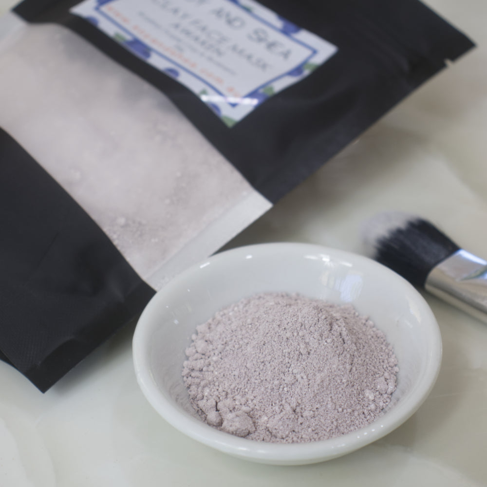 Small white bowl with Awaken Clay Face Mask Powder in a shade of purple.