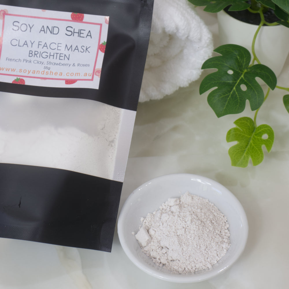 Soy and Shea Clay Face Mask packaging with a bowl of powder on a light background