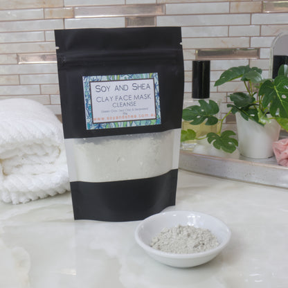Soy and Shea Clay Face Mask package on a bathroom counter with a bowl of mask powder.