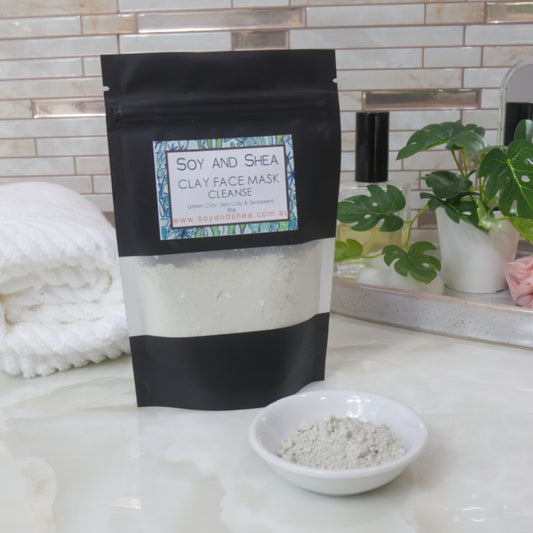 Soy and Shea Clay Face Mask package on a bathroom counter with a bowl of mask powder.