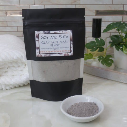 Soy and Shea Renew Clay Face Mask package on a bathroom counter with a bowl of dry mask powder.