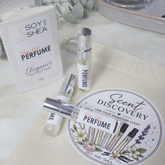 A selection of small, clear glass perfume sample bottles are present lying on a calico bag labelled as Scent Discovery.  Behind is a sample card packaging for the sample bottles