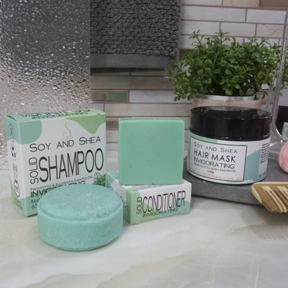 Soy and Shea hair care products including shampoo, conditioner, and hair mask on a bathroom counter. All products are in shades of green.