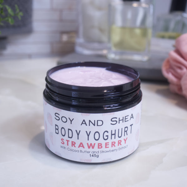 A black jar of Body Yoghurt sits on the bathroom counter without its lid revealing a pale pink cream